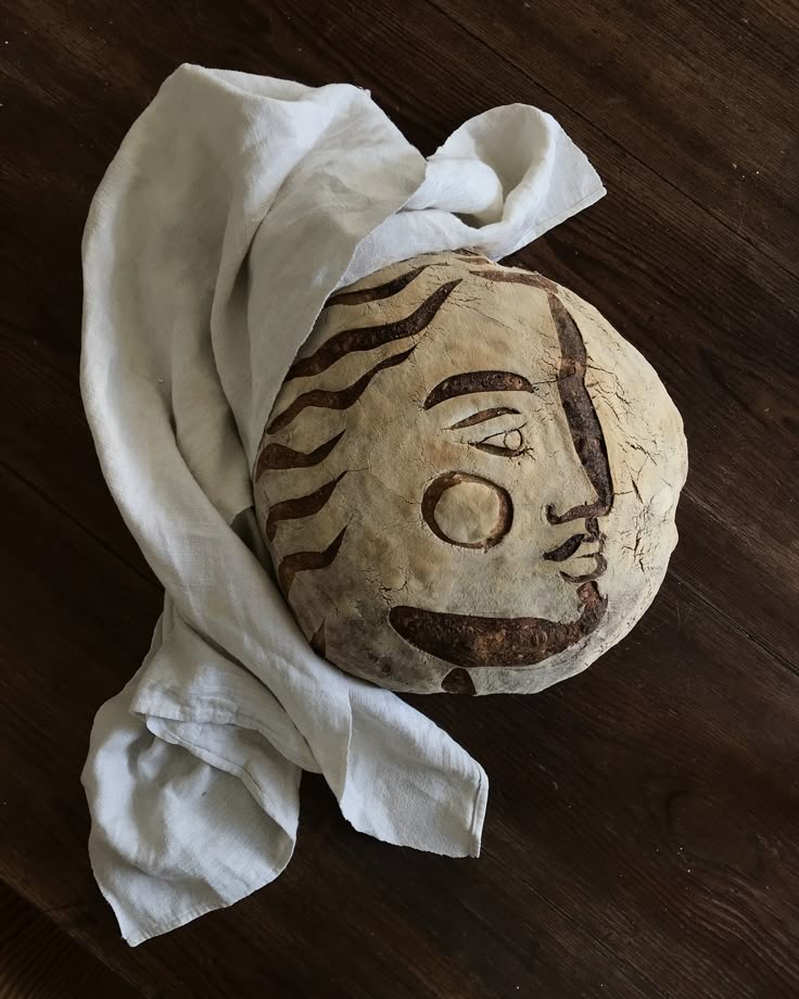 a piece of bread that has been made to look like a woman's face