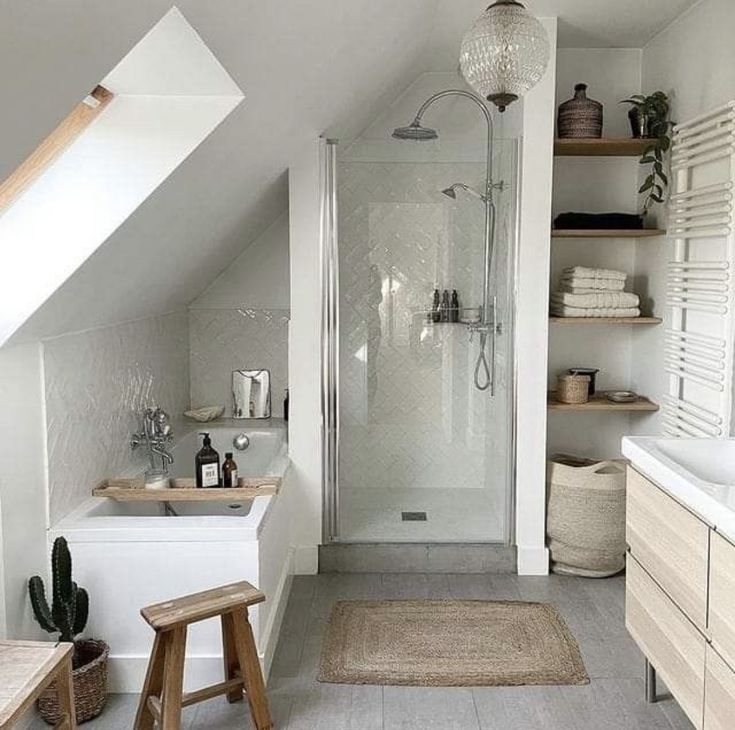 an attic bathroom with white walls and wood flooring, along with a walk in shower