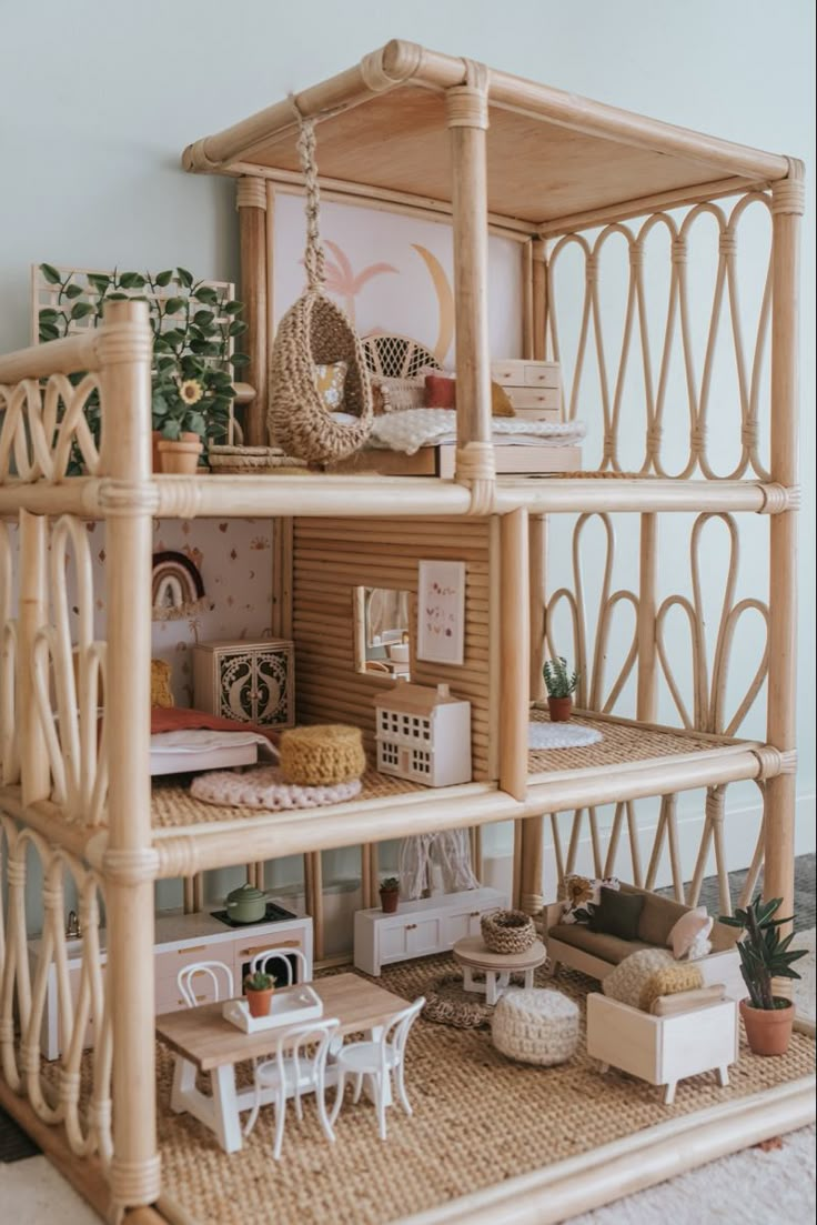 a doll house is shown with furniture and accessories on the shelves in front of it