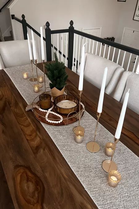 the table is set with candles and other items on it, along with some decorations