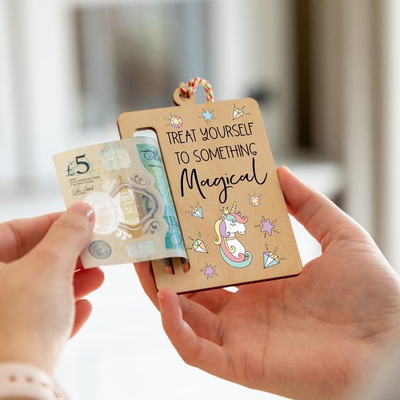 someone holding up a wooden magnet with the words treat yourself to something magical