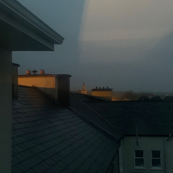 an image of a view from the top of a building at dusk with fog in the air