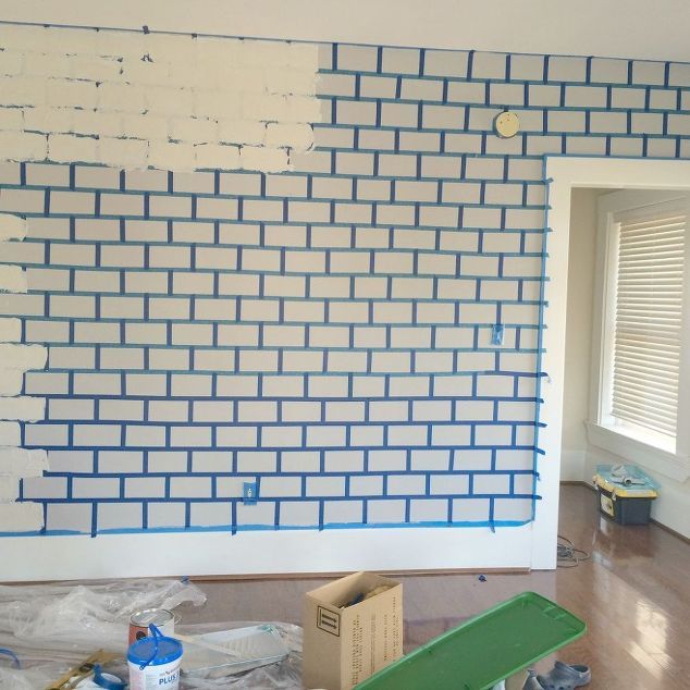 a room that has been painted with blue and white bricks on the wall, along with construction materials