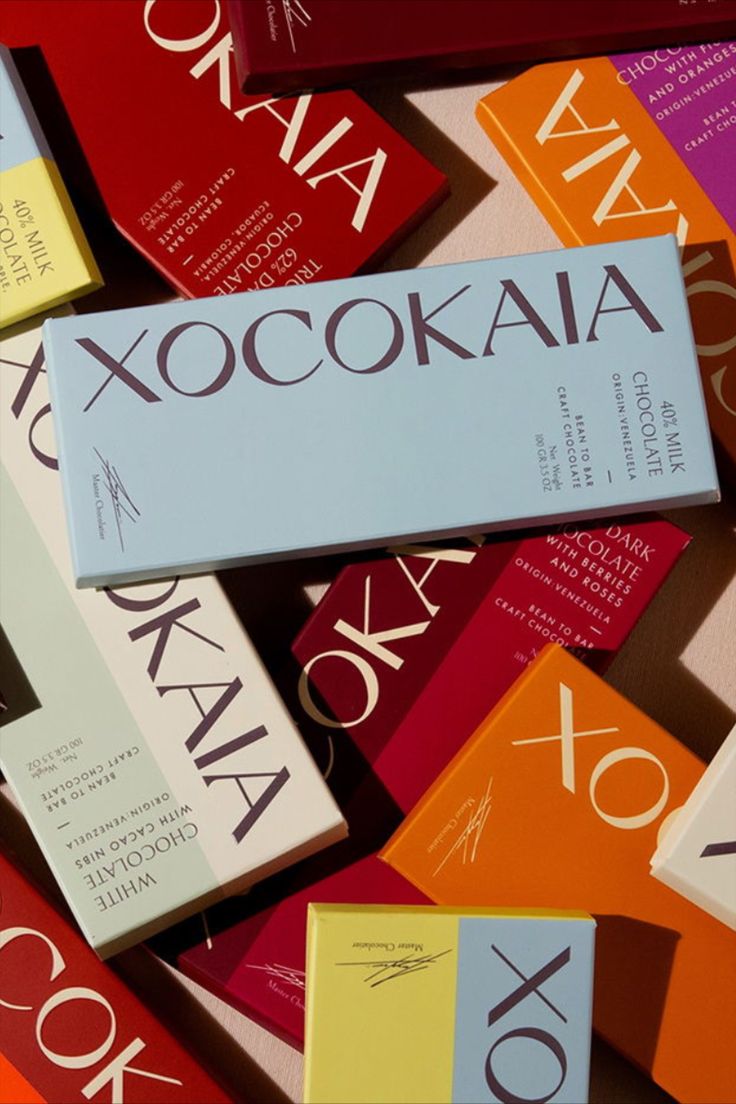 many different colored books stacked on top of each other with the word xocoka above them