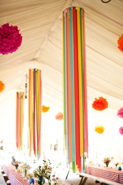 an open cell phone with colorful decorations hanging from the ceiling