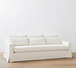 a white couch sitting on top of a hard wood floor