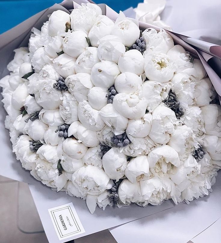 a bouquet of white flowers sitting on top of a table