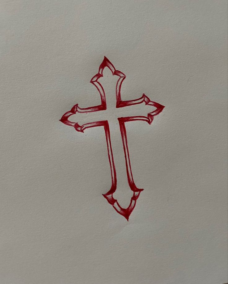 a cross drawn on paper with red ink