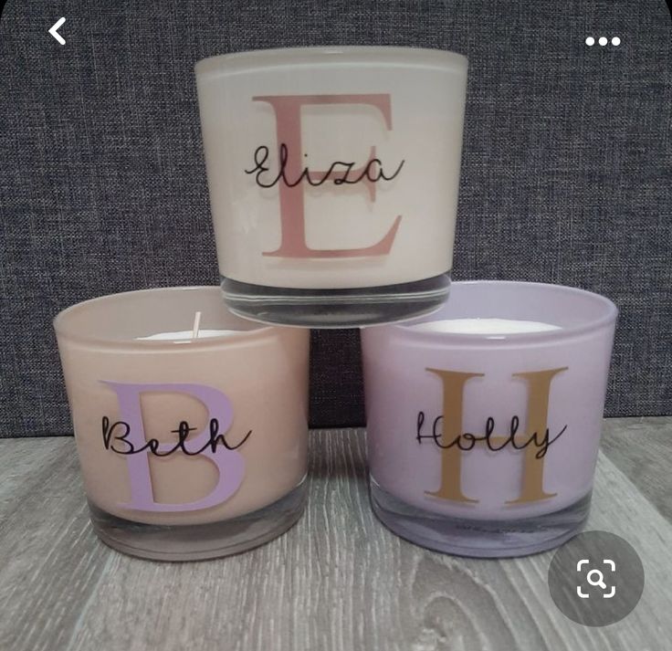 three candles with the letters e, b, and f painted on them sitting next to each other