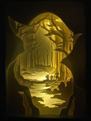 a paper cut artwork depicting two people walking in the woods