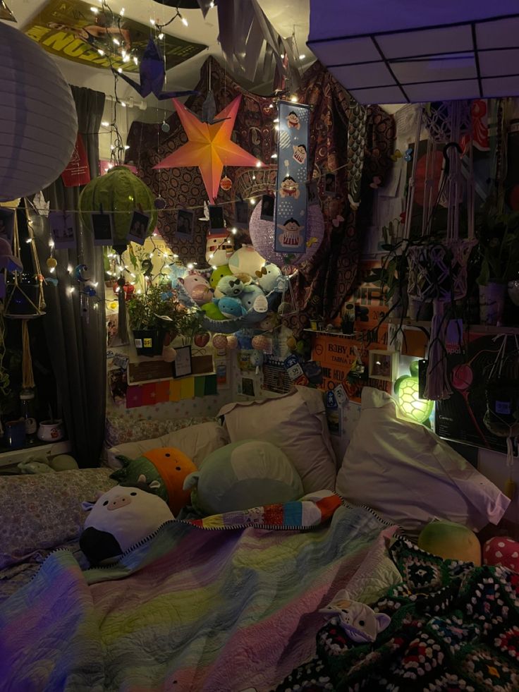 a bed with lots of stuff hanging from it's sides and lights on the ceiling