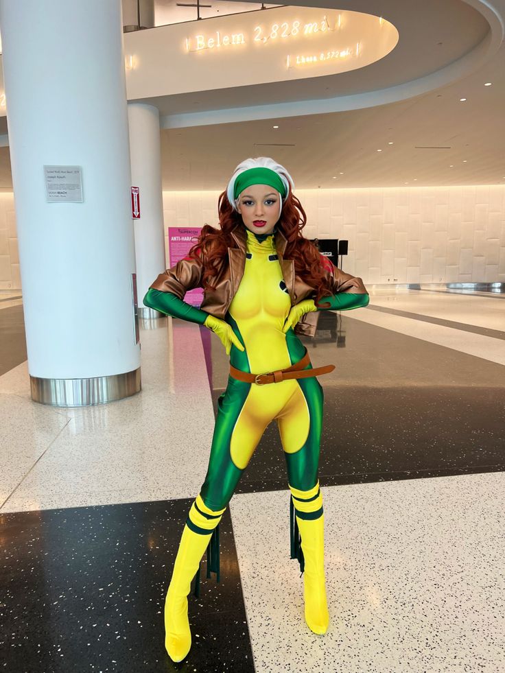 a woman in a yellow and green costume posing for the camera with her arms crossed