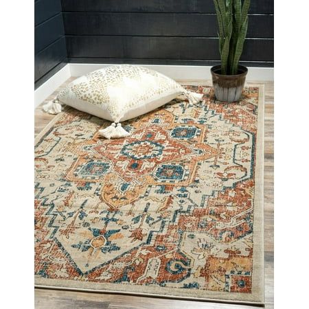 an orange and blue area rug with a plant on the floor in front of it