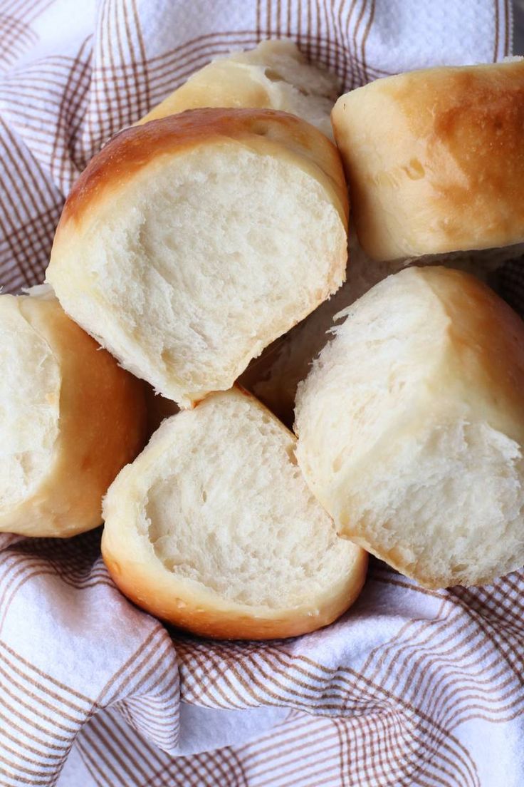 several pieces of bread sitting on top of a checkered cloth