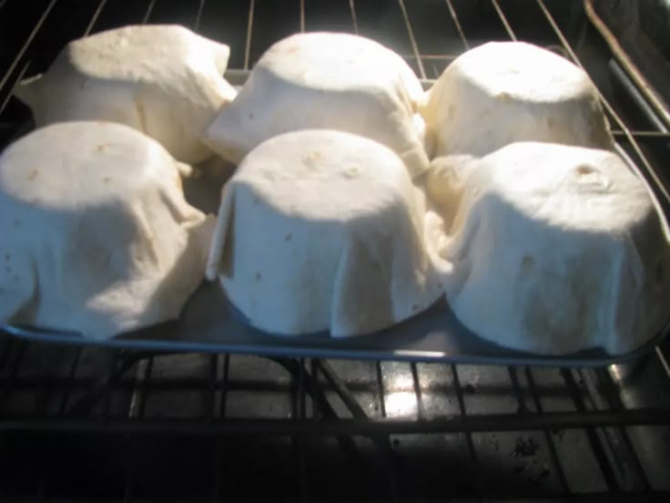 several uncooked marshmallows sitting in an oven