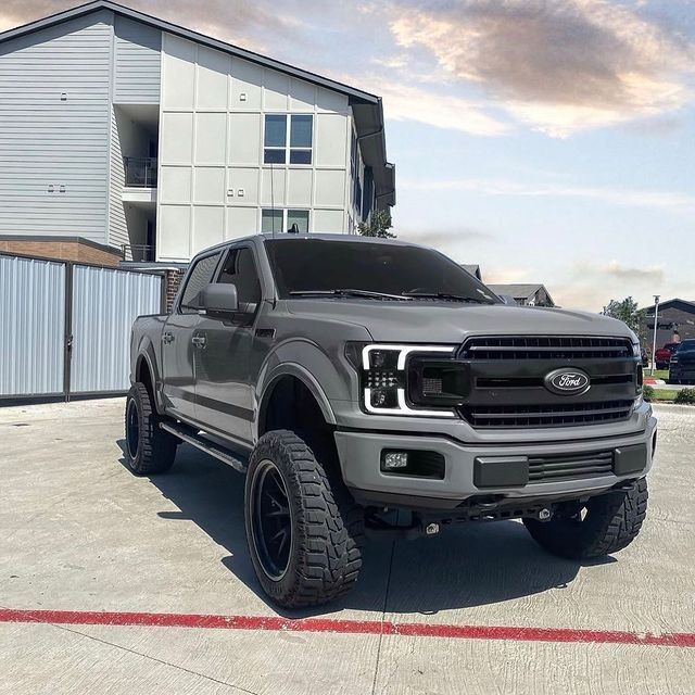 a gray truck parked in front of a building