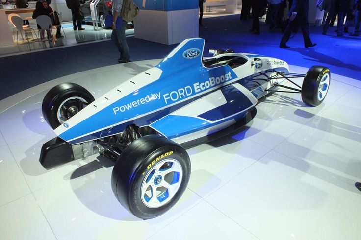 a blue and white race car is on display