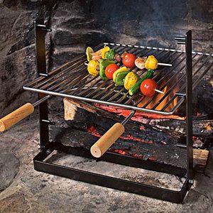 an outdoor grill with vegetables cooking on it