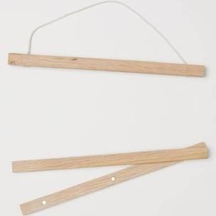 two pieces of wood are hanging on a string