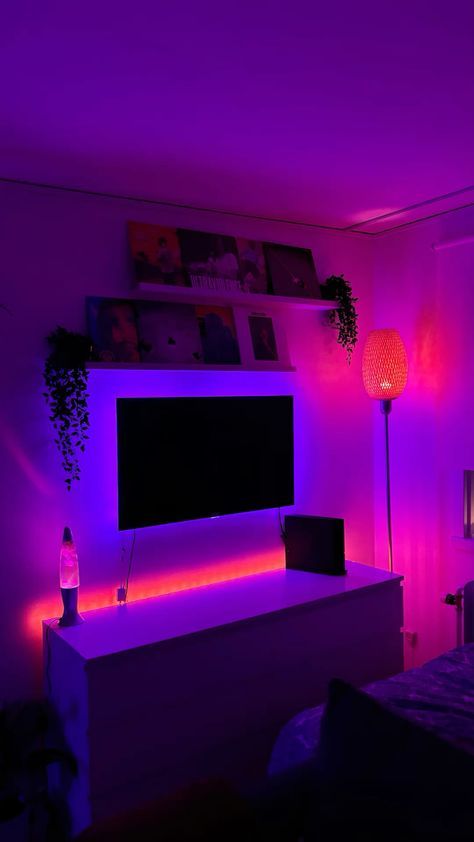 a bedroom with purple lighting and a flat screen tv