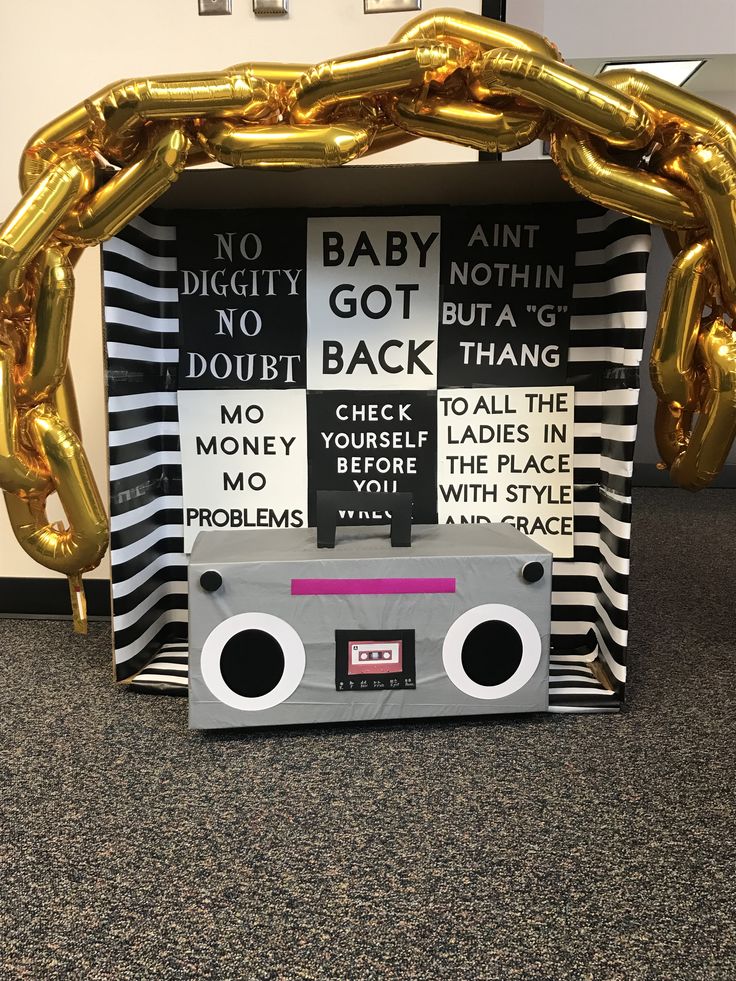 an old school tape recorder is decorated with gold balloons and a sign that says, no baby aint got back