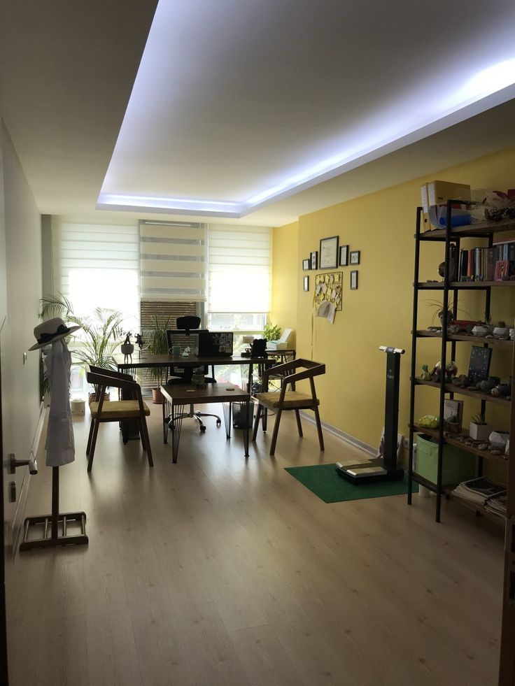 a living room filled with furniture and yellow walls