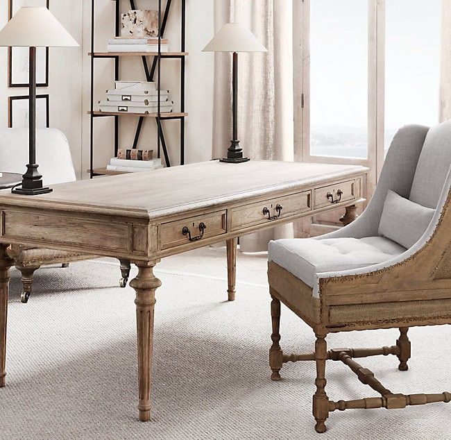 a living room filled with furniture and a large window next to a table covered in books