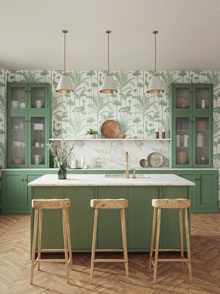 a kitchen with green cabinets and wooden stools in front of the island countertop