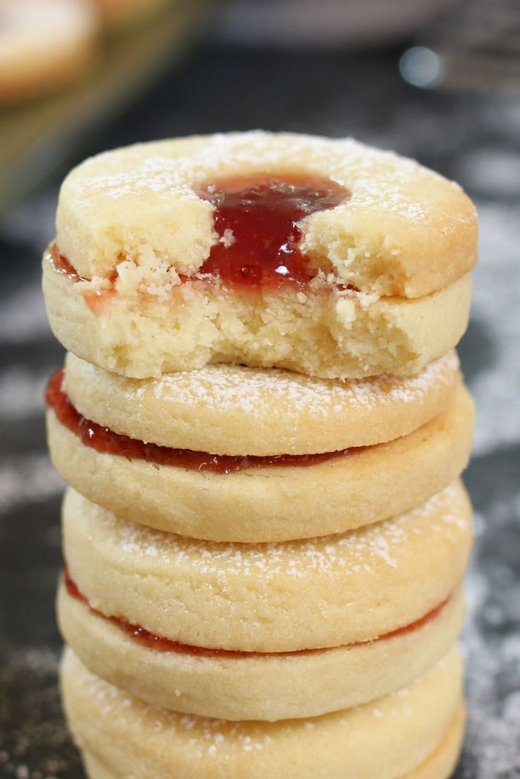 a stack of cookies with jam on top