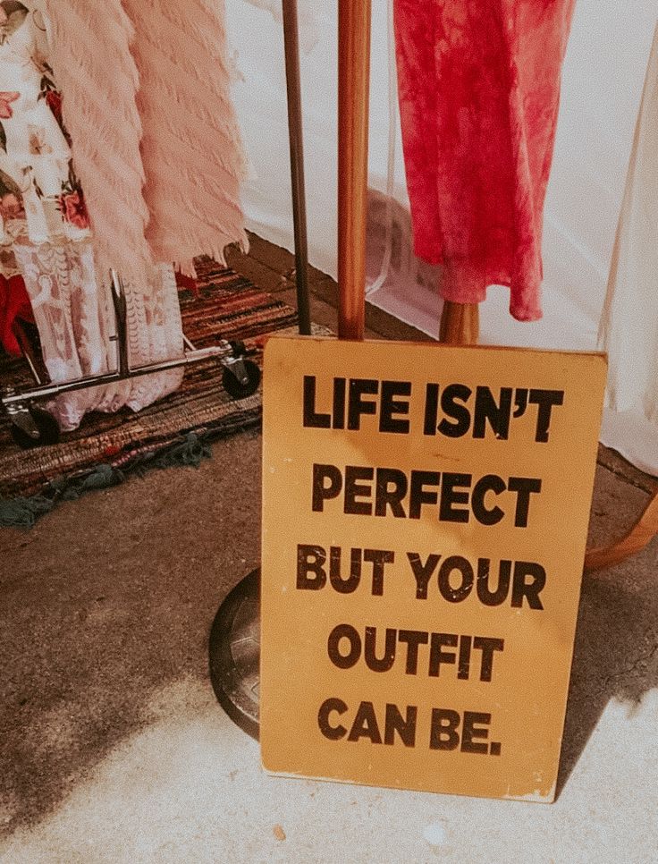 a sign that says life isn't perfect but your outfit can be hung up