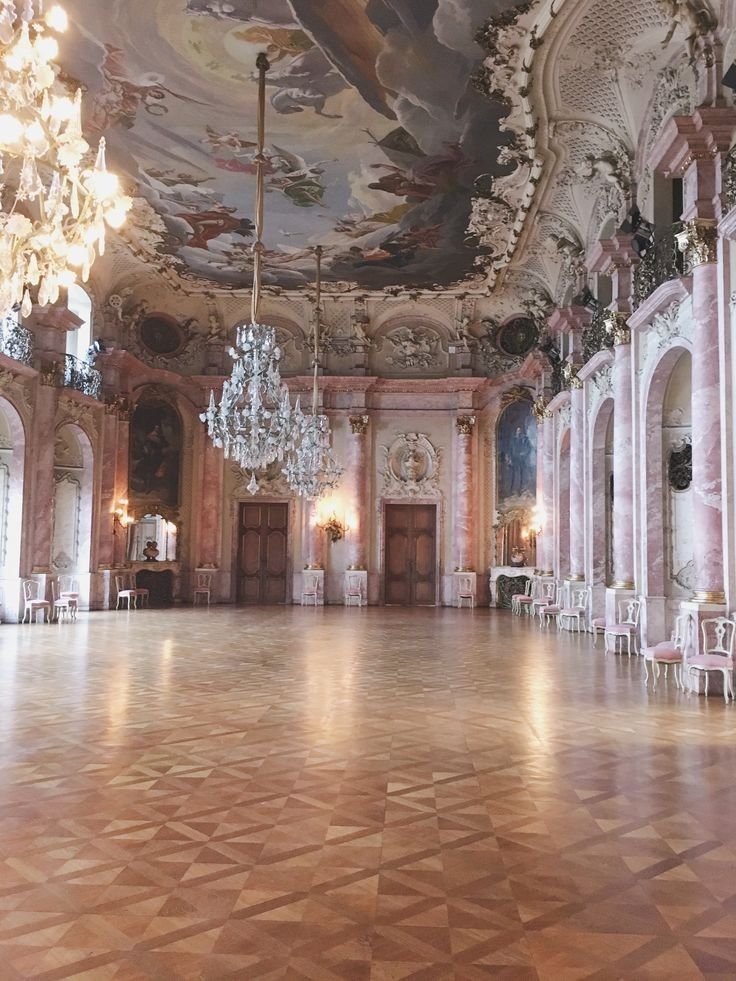 an ornate ballroom with chandeliers and paintings on the ceiling