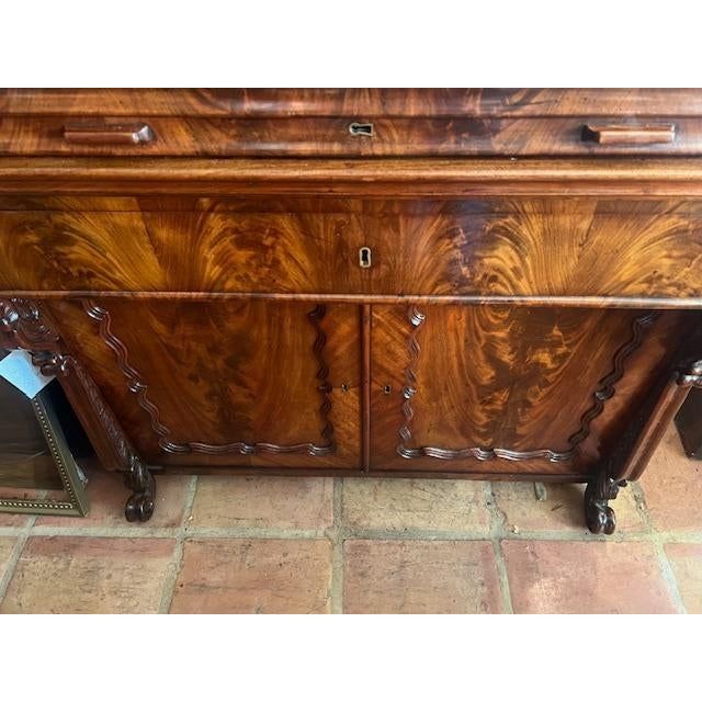 an old wooden dresser with drawers and knobs