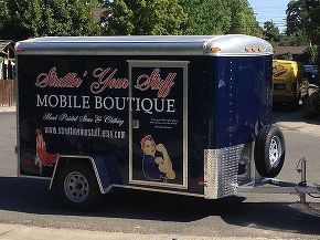 a mobile food truck is parked on the side of the road