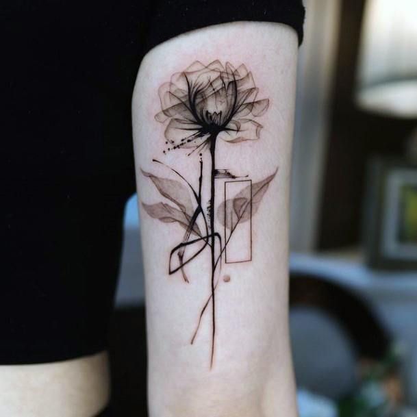 a black and white photo of a flower on the left inner arm with an abstract design