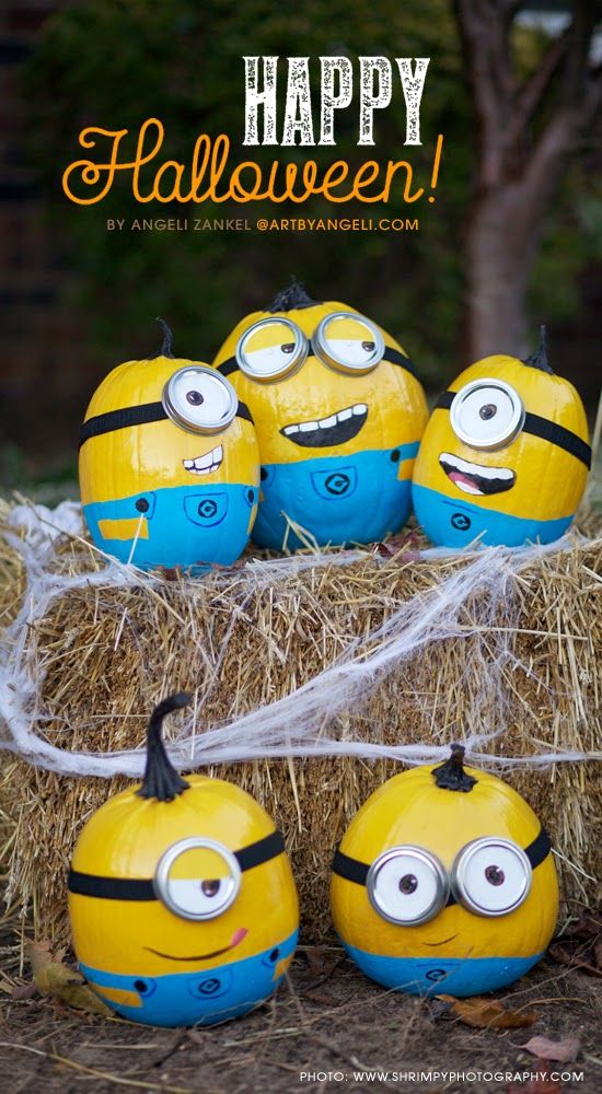 some yellow and blue minion pumpkins sitting on hay with the words happy halloween