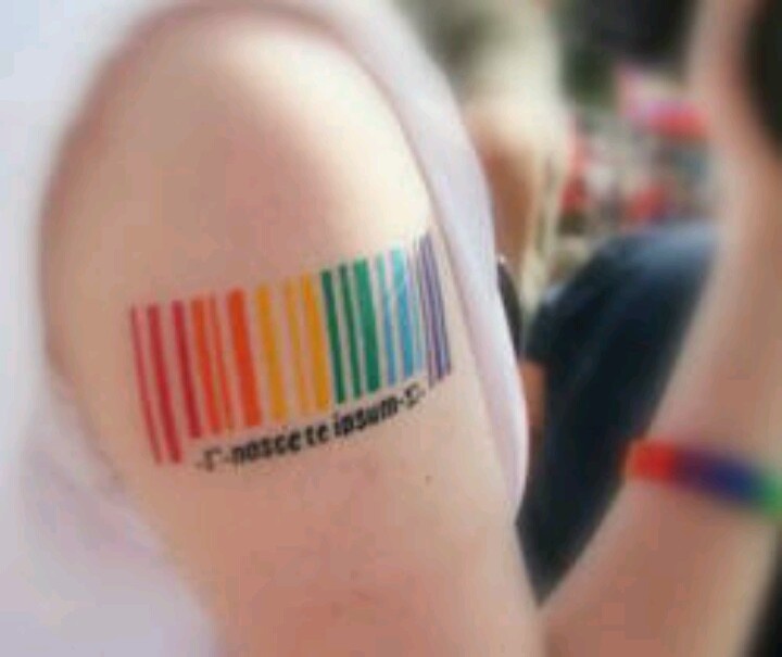 a person with a colorful tattoo on their arm that reads, music to listen -