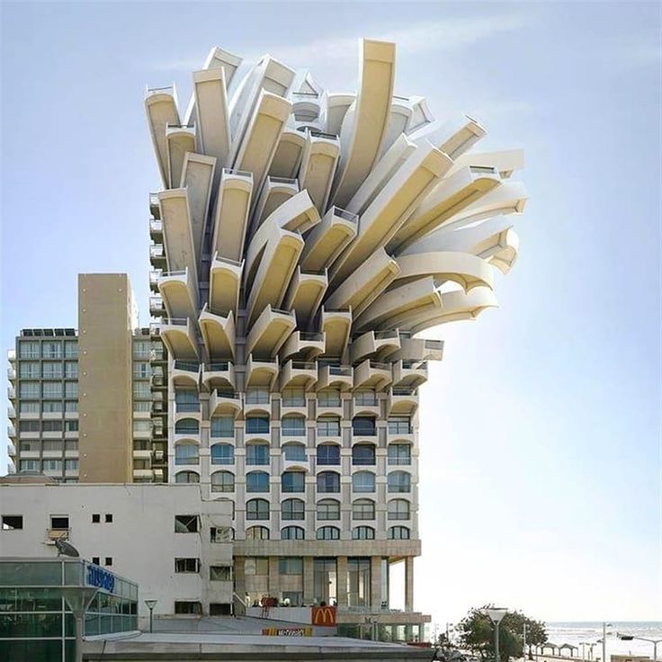 an unusual building with many windows and balconies on the roof is seen in this image