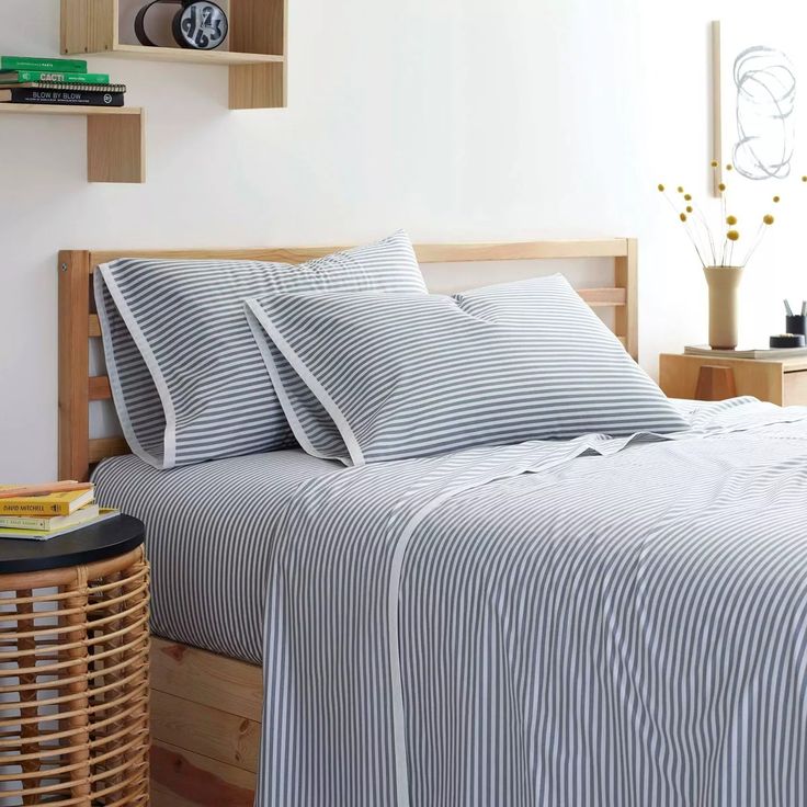 a bed with blue and white striped sheets