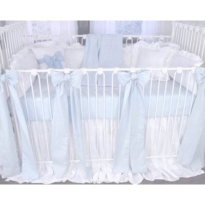 a baby crib with blue and white bedding