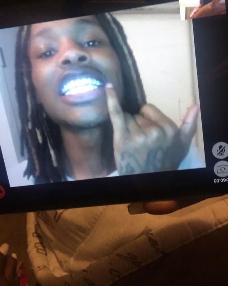 a person holding up a cell phone to take a selfie with their teeth whitening