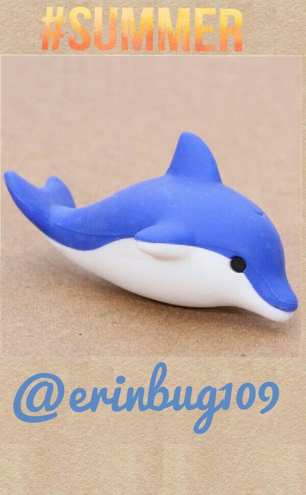 a blue and white dolphin toy sitting on top of a cardboard box with the words summer written below it