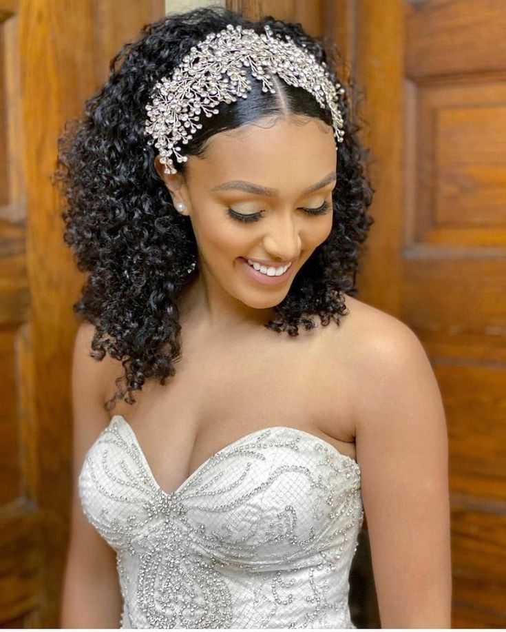 a woman in a wedding dress wearing a tiara