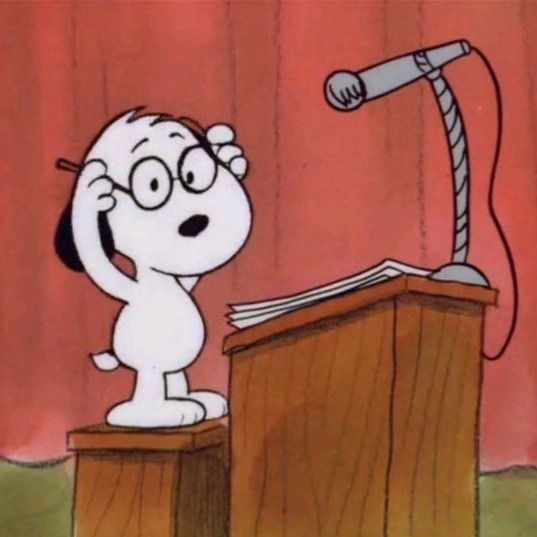 a cartoon dog standing on top of a wooden podium