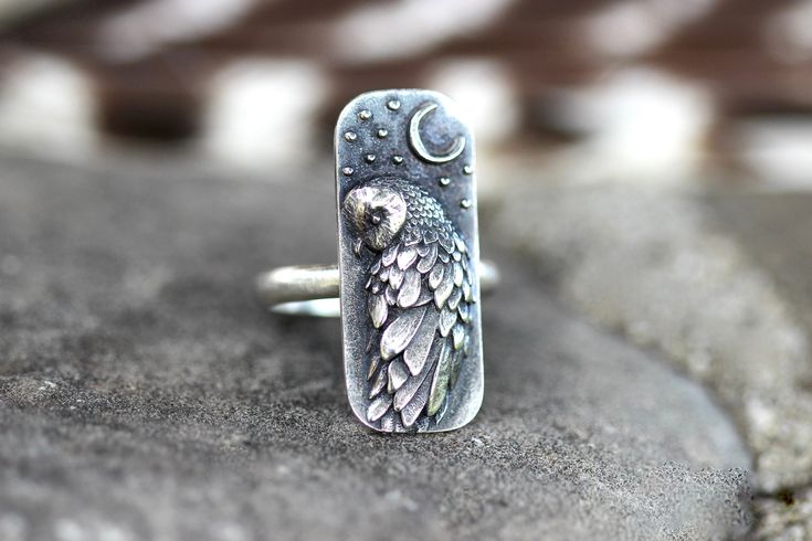 This listing is for one striking and unique sterling silver barn owl and moon ring. It features a detailed and dimensional barn owl under a crescent moon with stars. This thick and sturdy owl focal is fired onto 9 gauge half round wire. This ring is perfect for any owl and nature lover! It looks great solo or stacked with other rings and bands. - Choose your size at check-out! - Owl focal measures 28 mm by 12mm. - Ring band is 2mm wide by 1.5mm thick. - Made to order just for you! Please take note of estimated delivery times in the shipping section at checkout! Want to stack it with some awesome textured silver stacking bands? Find them here: https://www.etsy.com/listing/532906393/silver-stacking-rings-simple-silver-ring?ref=shop_home_active_16 Not sure of your ring size? Purchase one of t Witch Ring, Witch Rings, Ring Moon, Owl Ring, Mystical Jewelry, Silver Rings Simple, Witch Jewelry, Owl Jewelry, Moon Ring