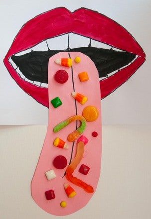 a paper plate with candy on it next to a drawing of a mouth and tongue