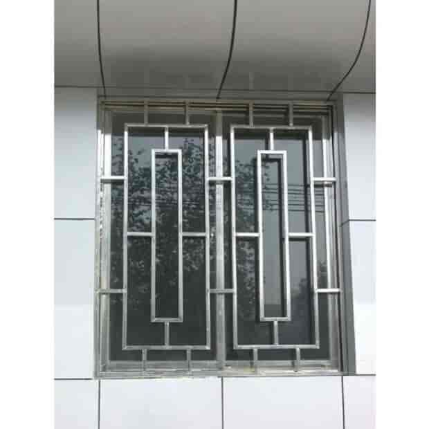 an image of a window that is on the side of a building with metal bars