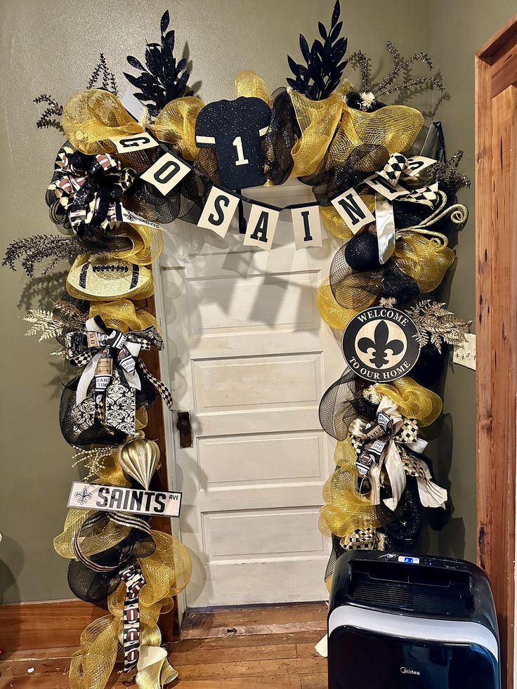 Attention New Orleans Saints fans ! Be the talk of your neighborhood with this beautiful, sparkling, black and gold Garling with stunning Saints decor, beautiful designer ribbon, and several large New Orleans Saints signs, Uniforms, footballs, and ornaments. You will sure be the talk of your neighborhood!  I have been in this business for over 26 years and I decorate everything from door wreaths, Christmas trees, door, swags, arrangements, mantels For each and every season of the year. Please co New Orleans Christmas Tree, Saints Wreaths, Door Wreaths Christmas, New Orleans Christmas, Door Swags, Wreaths Christmas, Seasons Of The Year, New Orleans Saints, Gold Christmas