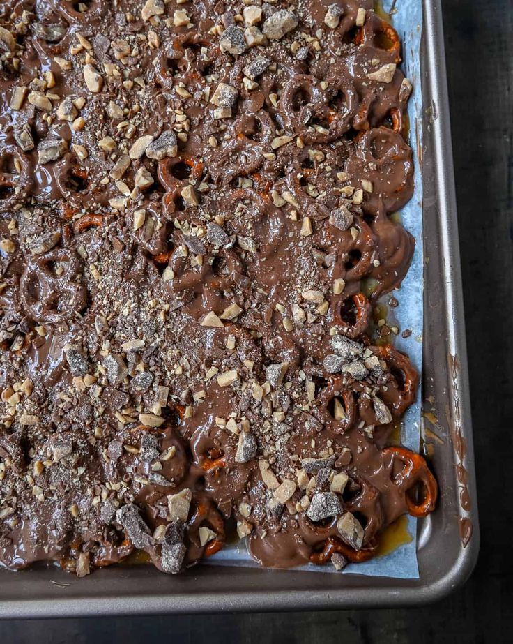 a pan filled with chocolate and nuts on top of a table