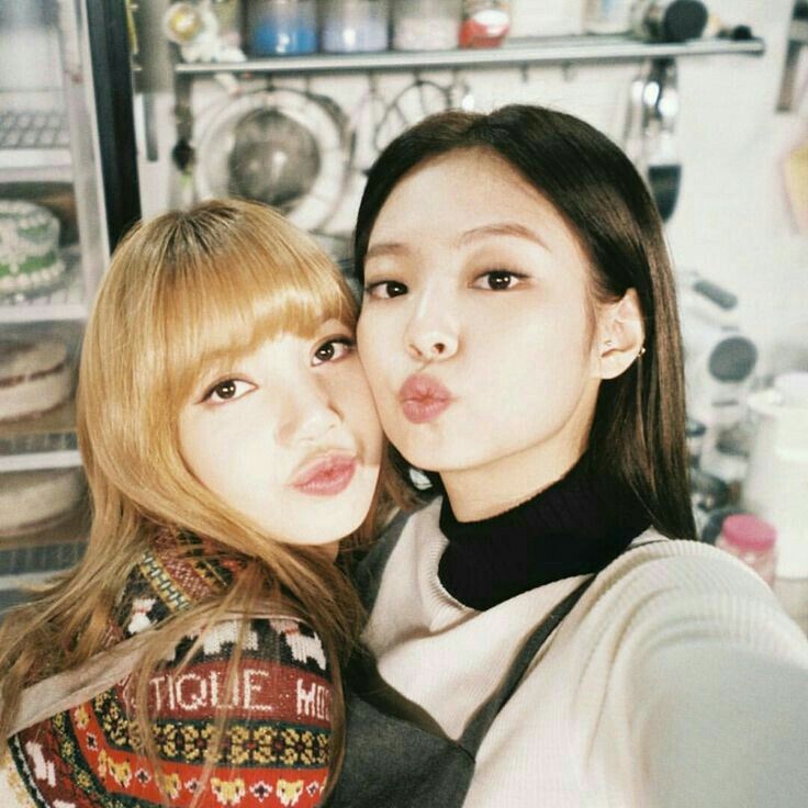 two young women taking a selfie in the kitchen