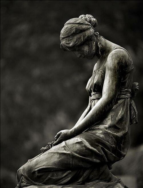 a black and white photo of a statue with the words queen city nuren on it